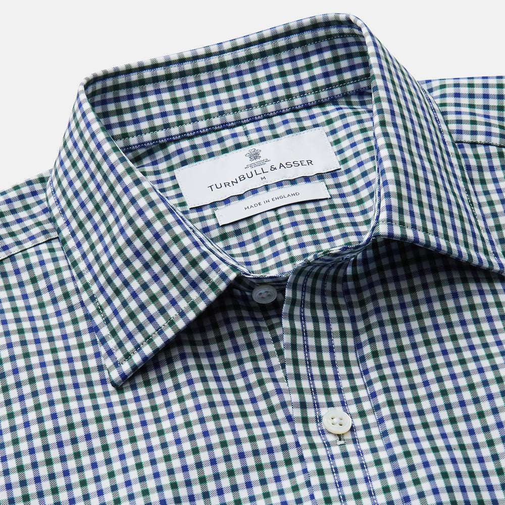 The Turnbull & Asser Green and Blue Cotton Multi Check Weekend Fit Finch Shirt features long sleeves, a pointed collar, and buttoned cuffs—perfect for versatile style. Laid flat on a white background.