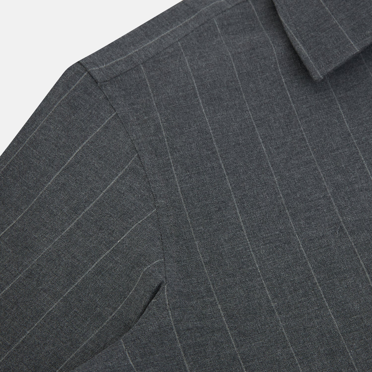 View 6 of product The Charcoal Melange Wide Stripe Westminster Shirt from Turnbull & Asser features long sleeves, a tailored fit, pointed collar, buttoned cuffs, and subtle wide stripes, shown laid flat on a white background.