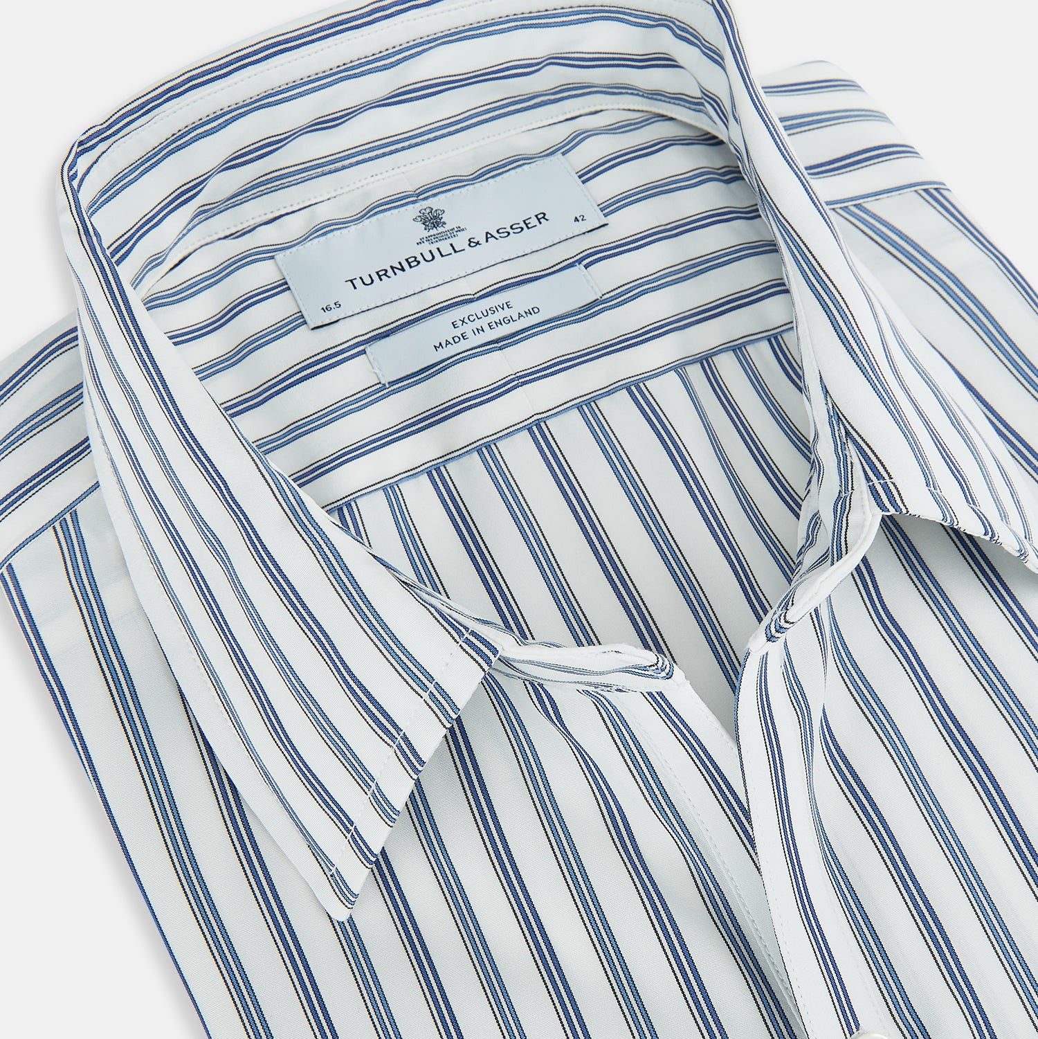 View 2 of product The SAPPHIRE BLUE MULTI TRACK STRIPE WINDSOR SHIRT by Turnbull & Asser features long sleeves, button-up front, classic collar, blue and white vertical stripes, buttoned cuffs, and showcases British craftsmanship on a white background.