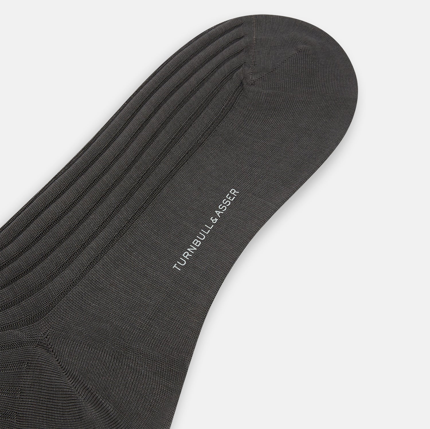 View 3 of product A single Concrete Mid-Length Sock by Turnbull & Asser, crafted from mercerised Egyptian cotton for refined comfort, is shown upright on a white background with the toe pointing left and the cuff at the top.