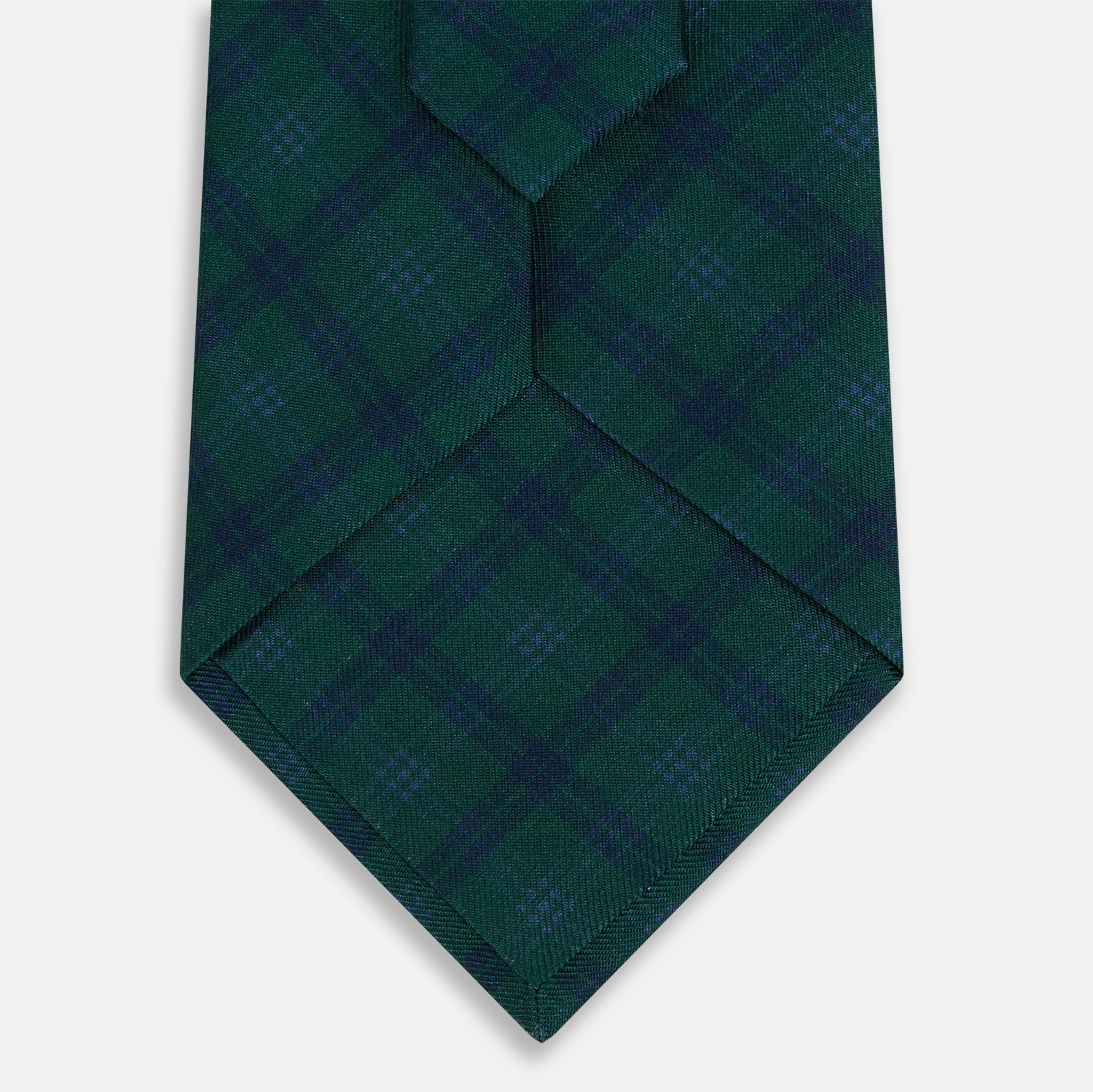 View 3 of product The Turnbull & Asser Forest Melange Tartan Plaid Silk Tie features a classic green and blue plaid design, rolled up and displayed on a plain light background—reflecting timeless Scottish heritage.