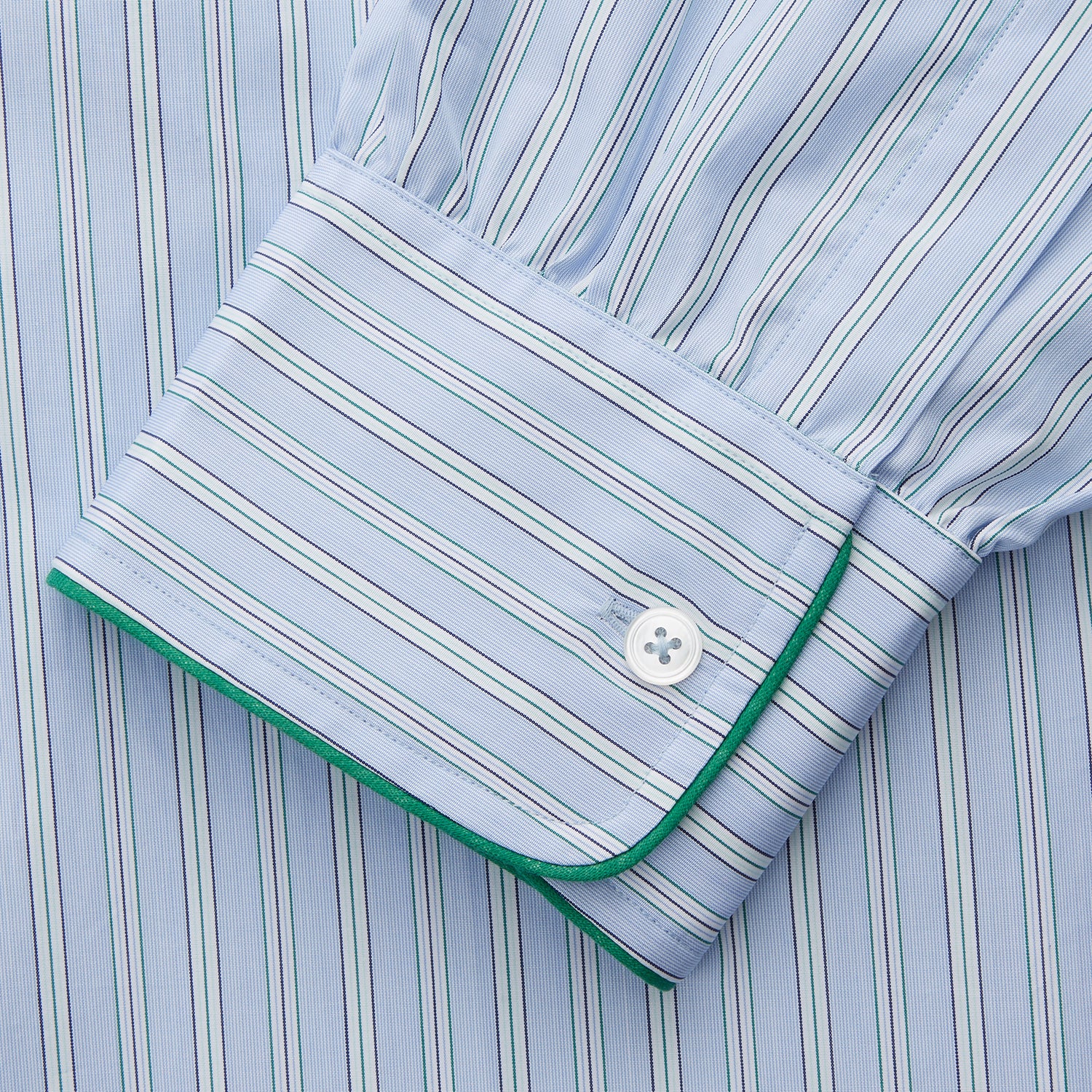 View 3 of product The Turnbull & Asser Blue and Green Stripe Poplin Cotton Nightshirt features long sleeves, a rounded hem, front pocket, green-trimmed collar and pocket, and front buttons—ideal men's nightwear for any season.