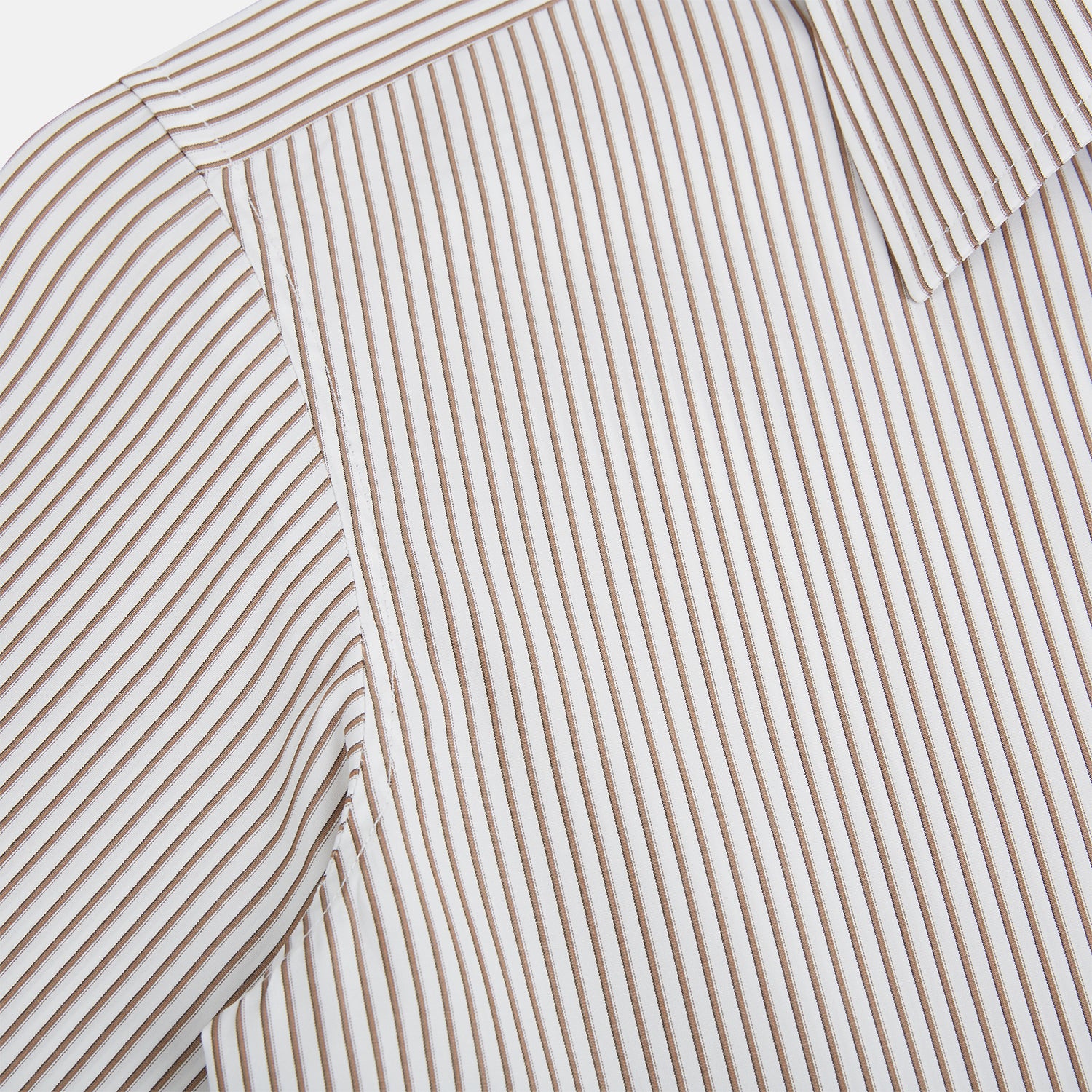View 6 of product The Turnbull & Asser Coffee Multi Stripe Westminster Shirt features long sleeves, a button-up front, subtle beige and white stripes, a pointed Turnbull collar, and buttoned cuffs—expertly crafted in Britain and shown flat on a white background.