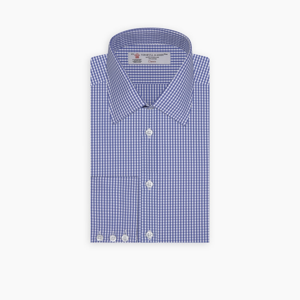 The Turnbull & Asser Mid-Blue Gingham Check Shirt features a T&A collar and 3-button cuffs, crafted from cotton and displayed folded on a plain white background.