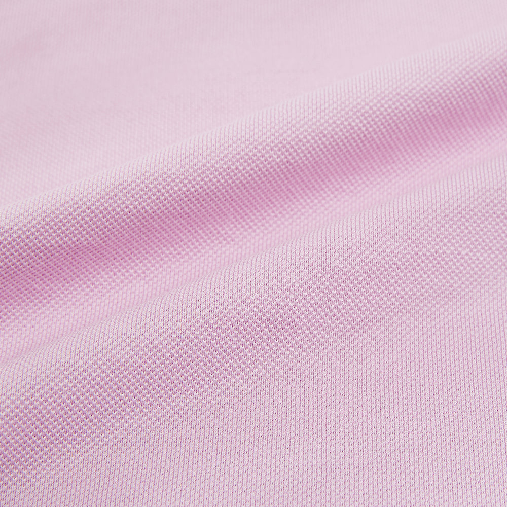 The Pink Rugby Polo Shirt by Turnbull & Asser features long sleeves, a collar, and V-neck opening in luxury cotton, shown flat on a white background.