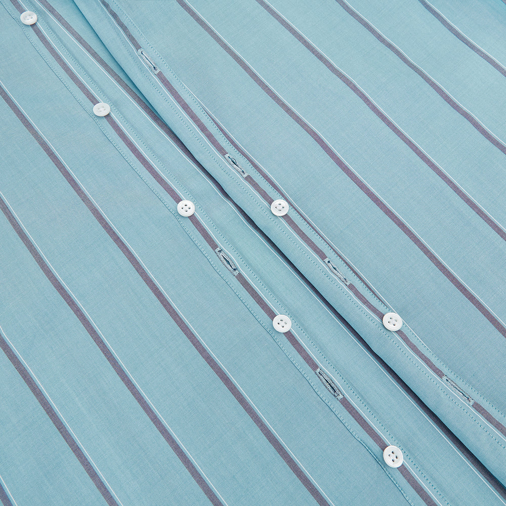 The Cendre Blue Track Stripe Westminster Shirt by Turnbull & Asser features a light blue hue, dark vertical stripes, button-down front, classic collar, and buttoned cuffs—showcasing British craftsmanship.