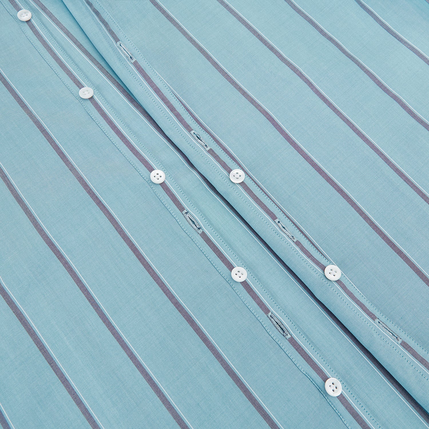 View 7 of product The Cendre Blue Track Stripe Westminster Shirt by Turnbull & Asser features a light blue hue, dark vertical stripes, button-down front, classic collar, and buttoned cuffs—showcasing British craftsmanship.