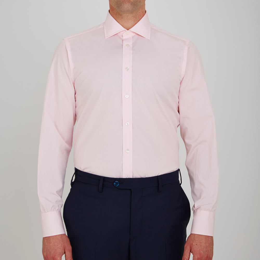 The Turnbull & Asser Pink Poplin Slim Fit Regent Collar Shirt features white buttons and a slim fit label, neatly folded and displayed on a plain white background.