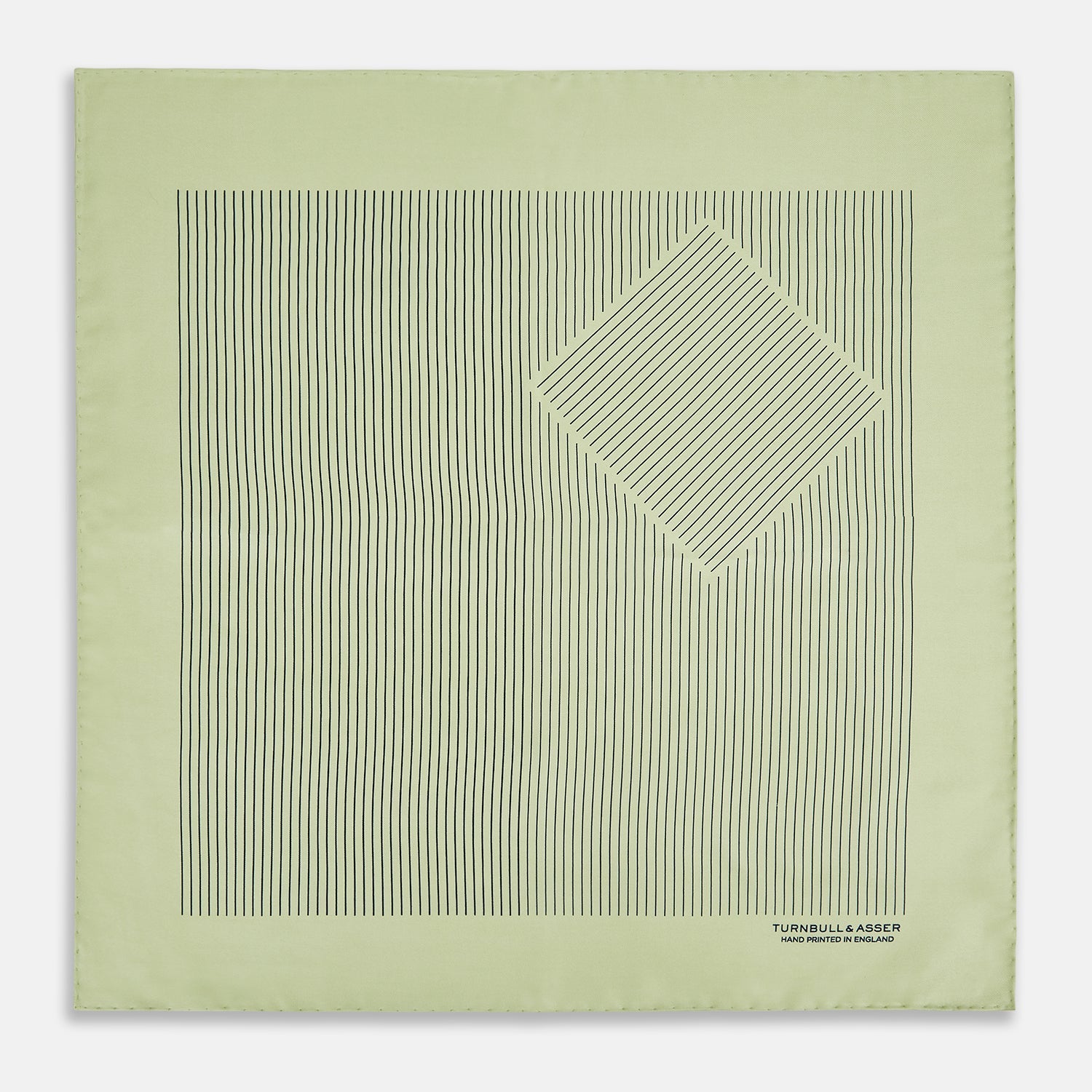 View 3 of product The Melon Green Stripe Silk Pocket Square by Turnbull & Asser features thin vertical black lines on light green silk, neatly folded to display both sides. The lower corner reads “TURNBULL & ASSER HAND PRINTED IN ENGLAND.”.
