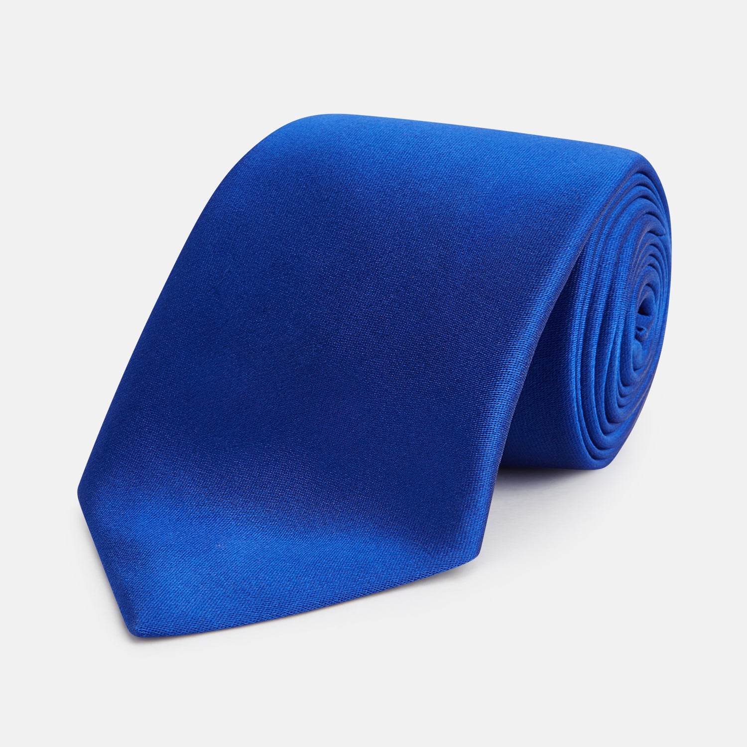 View 1 of product The Turnbull & Asser SATIN CRUISE TIE, in vibrant royal blue with a smooth, lustrous finish, creates a striking contrast against a plain white background.