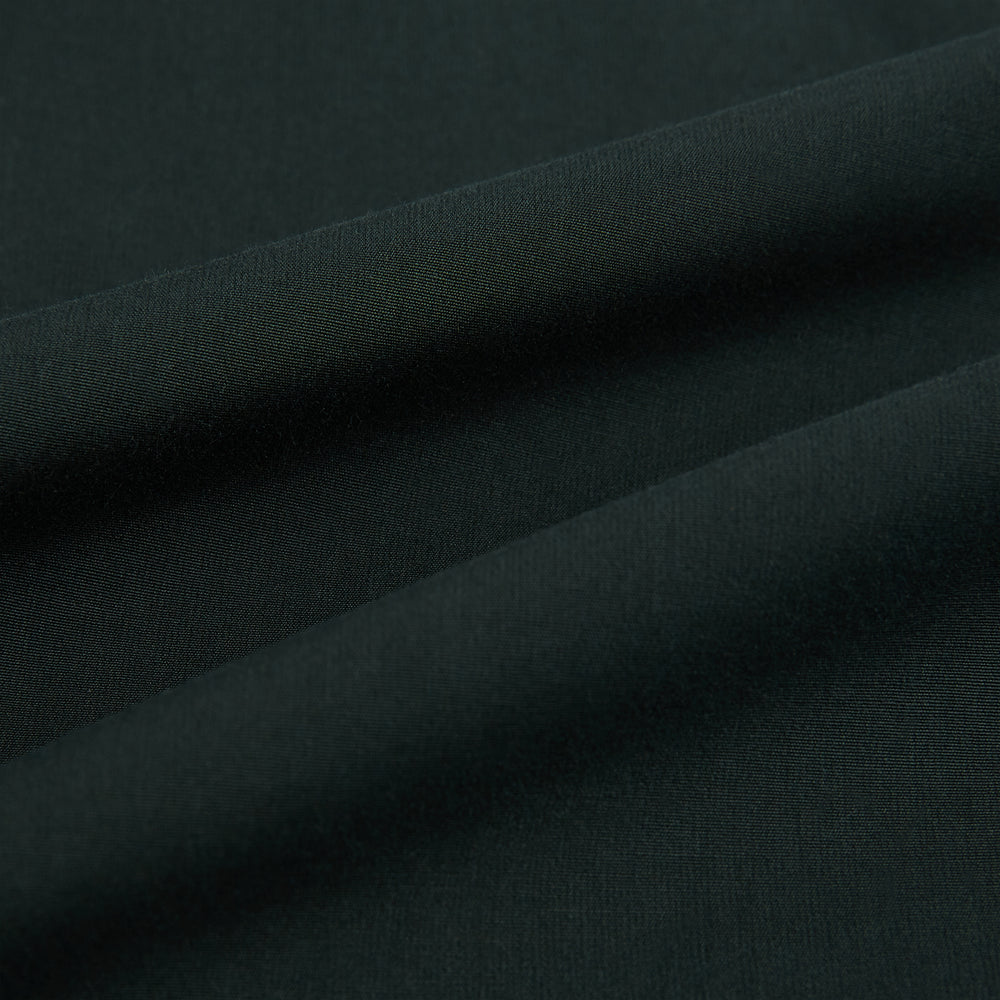 The FOREST GREEN WINDSOR SHIRT by Turnbull & Asser features long sleeves, a Windsor collar, and buttoned cuffs, reflecting British craftsmanship. Displayed on a plain white background.