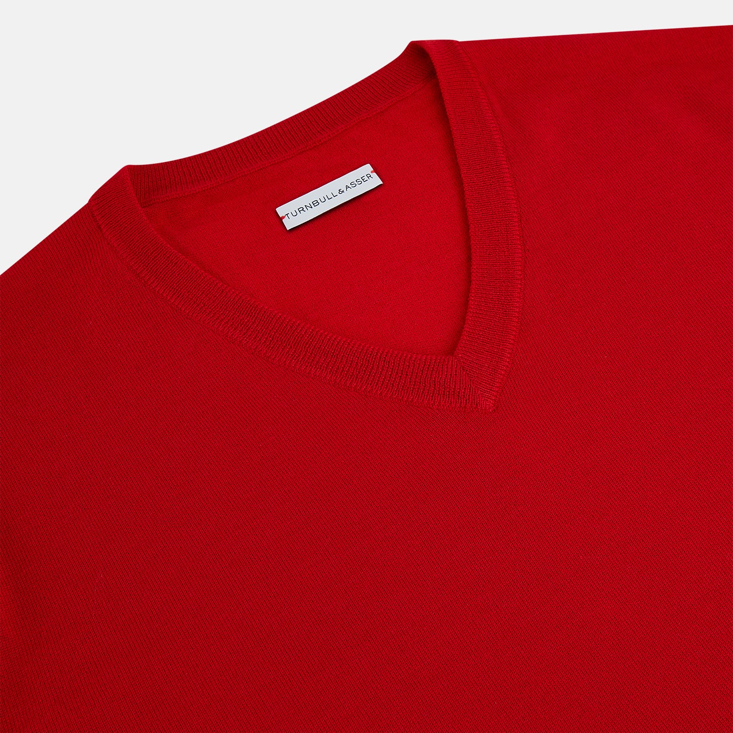 View 2 of product The Turnbull & Asser Red Fine Merino V-Neck Jumper, a classic long-sleeve knitwear piece, is shown on a white background.