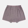 View 2 of product The Turnbull & Asser Burgundy Houndstooth Godfrey Boxer Shorts are luxury men's underwear made from Italian cotton, featuring an elastic waistband and a small maroon and white houndstooth pattern.