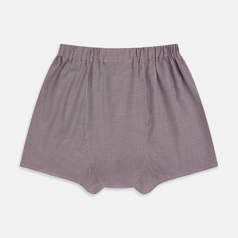 The Turnbull & Asser Burgundy Houndstooth Godfrey Boxer Shorts are luxury men's underwear made from Italian cotton, featuring an elastic waistband and a small maroon and white houndstooth pattern.