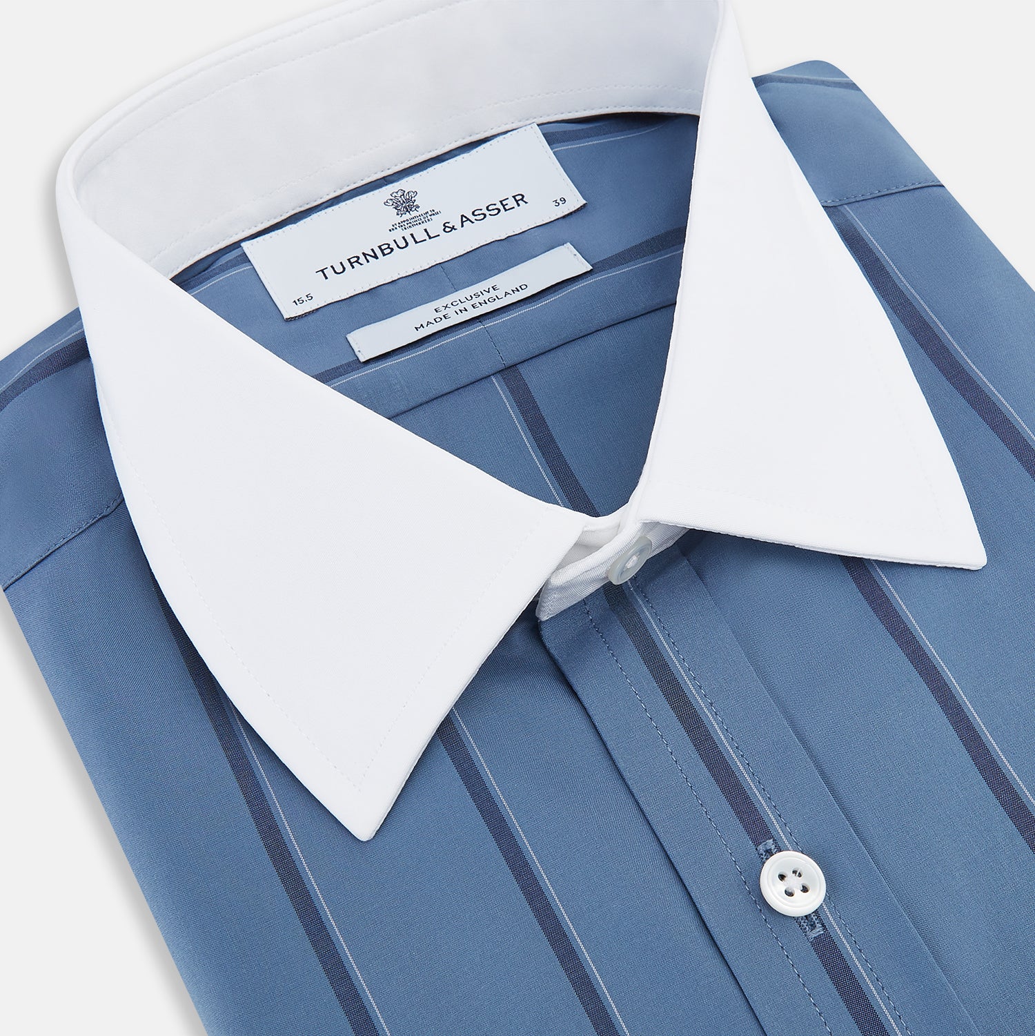 View 2 of product The Turnbull & Asser Steel Grey Track Stripe Shirt features vertical black stripes, a contrast white T&A collar, and white cuffs, shown against a plain light background.