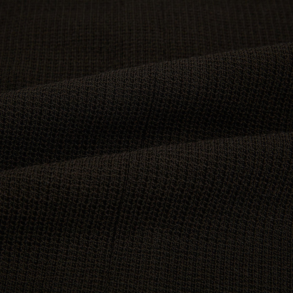 The Turnbull & Asser Dark Chocolate Greenwich Knitted Overshirt is crafted from Italian wool, with a classic collar, two flap chest pockets, and a concealed button front—offering a sleek cardigan alternative. Shown on a white background.