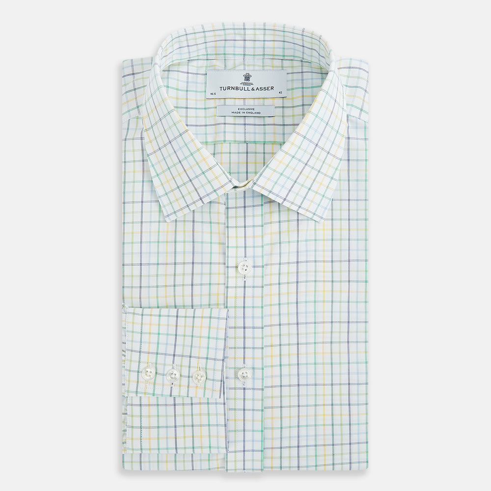 The Turnbull & Asser Multi Tone Double Grid Check Mayfair Shirt is a long-sleeve, button-up with a classic collar, showcasing pure cotton light blue, green, and yellow grid checks on white, neatly displayed flat against a white surface.