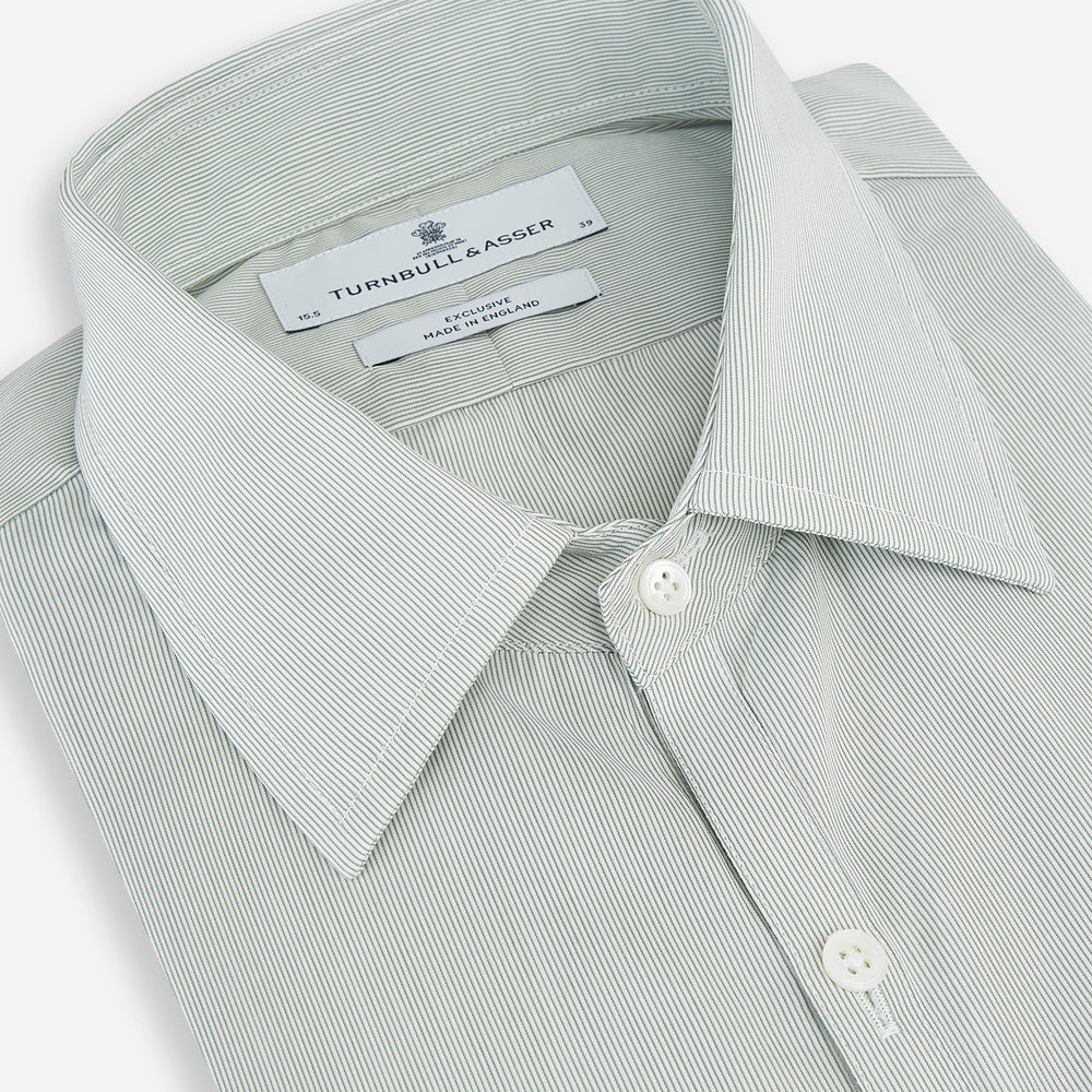 A dark green hairline stripe Westminster shirt by Turnbull & Asser, featuring long sleeves, a classic collar, tailored fit, white front buttons, and buttoned cuffs, laid flat on a white background.