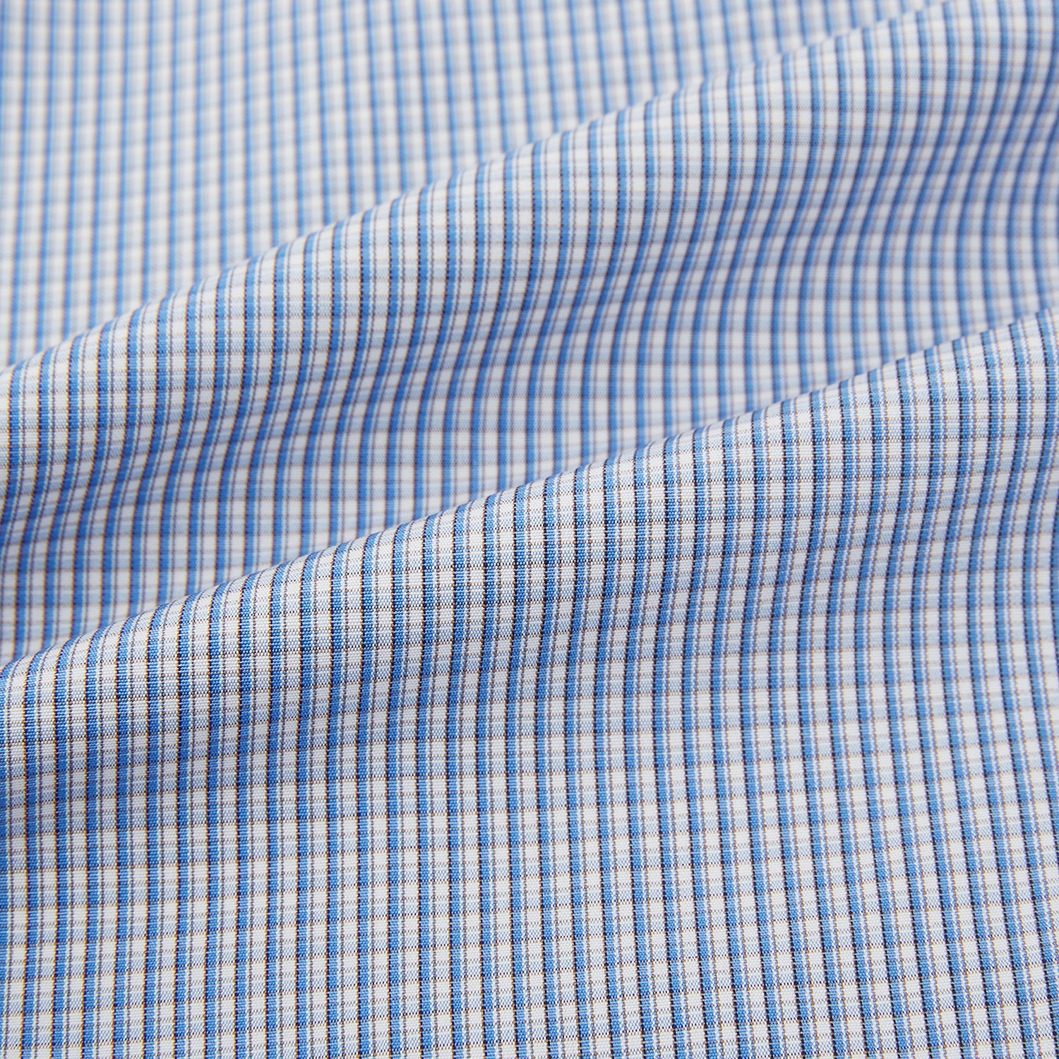 View 6 of product The Turnbull & Asser Pale Blue Micro Graph Check Mayfair Shirt features a small blue and white check pattern, classic T&A collar, white buttons, and buttoned cuffs. Presented on a plain white background.