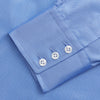 View 5 of product The Turnbull & Asser "The World Is Not Enough" blue cotton Istanbul shirt, as seen on James Bond, is a light blue oxford long-sleeve button-up with a pointed collar and white buttons, displayed on a white background.