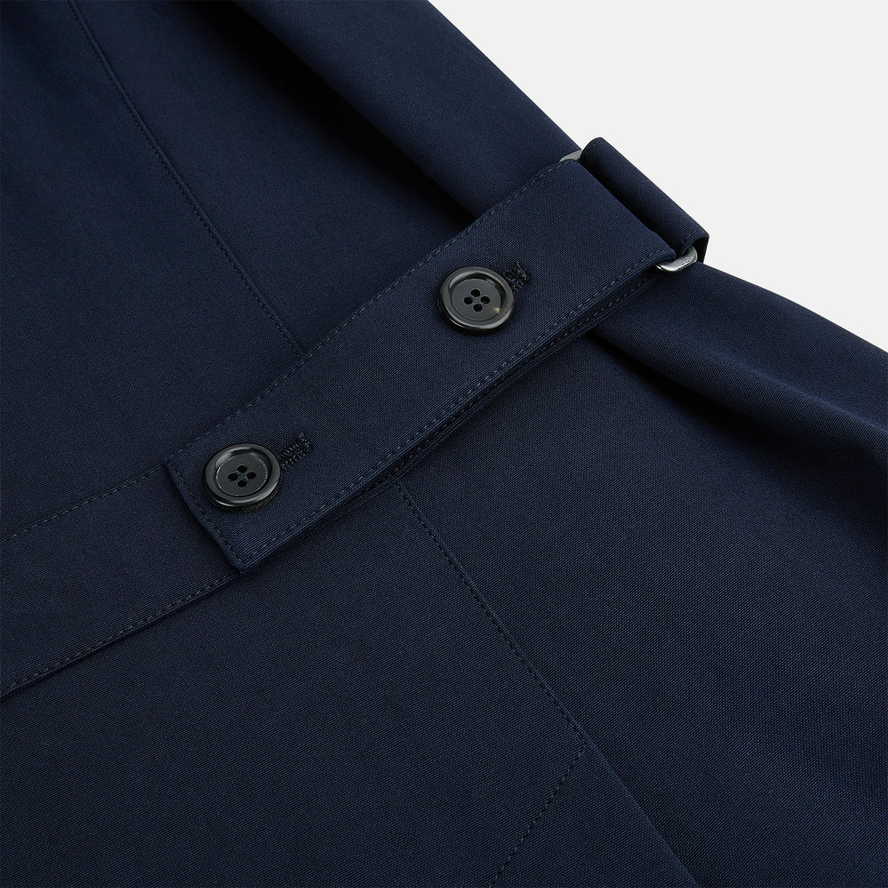 A Navy John Arthur Trench Coat by Turnbull & Asser, featuring a collar, button closure, adjustable cuff straps, two slanted front pockets, and a chest zip pocket, is displayed flat on a white background.