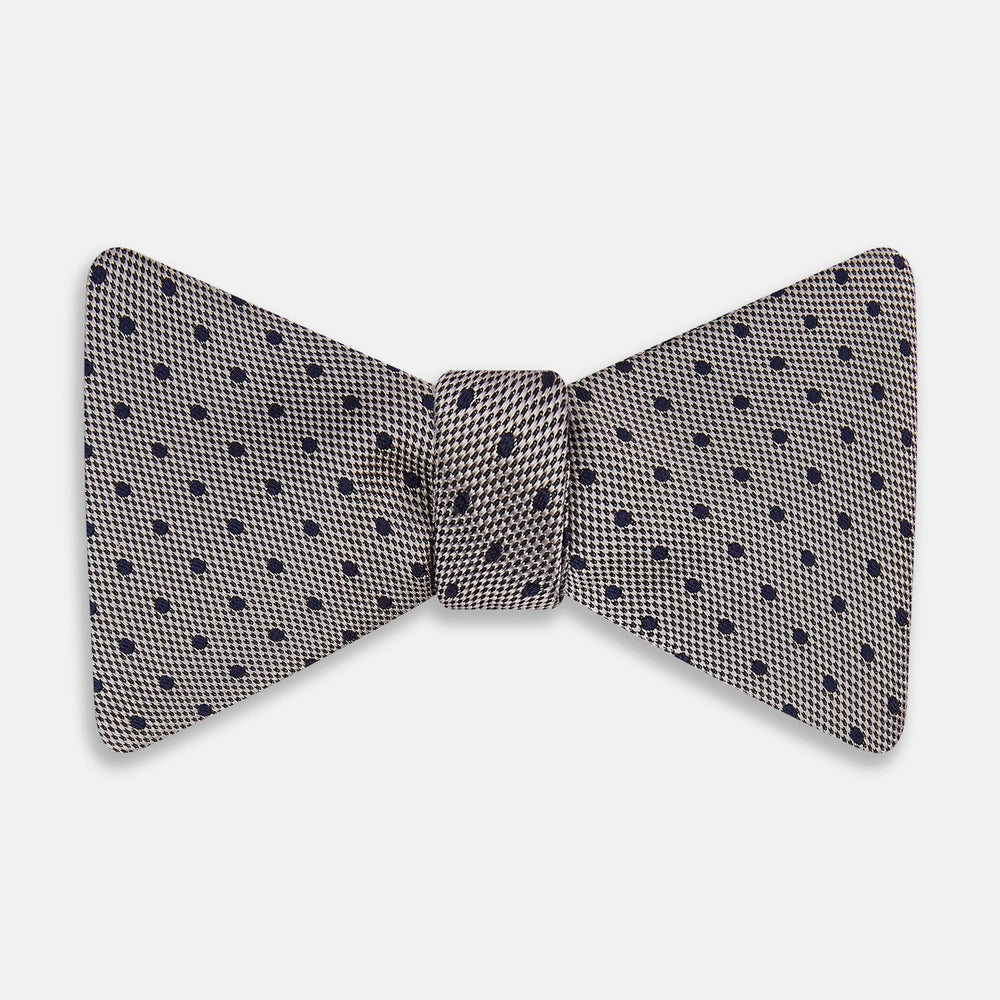 The Turnbull & Asser Navy and Silver Micro Dot Silk Bow Tie, featuring a refined dot pattern, is displayed on a white background.