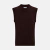 View 1 of product The Turnbull & Asser Burgundy Fine Merino V-Neck Vest is a sleeveless knitwear piece with ribbed trim at the neck, armholes, and hem, shown against a plain white background.