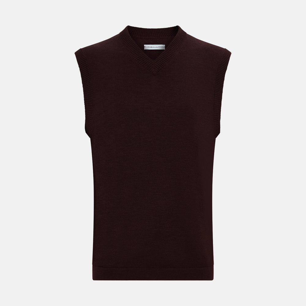 The Turnbull & Asser Burgundy Fine Merino V-Neck Vest is a sleeveless knitwear piece with ribbed trim at the neck, armholes, and hem, shown against a plain white background.