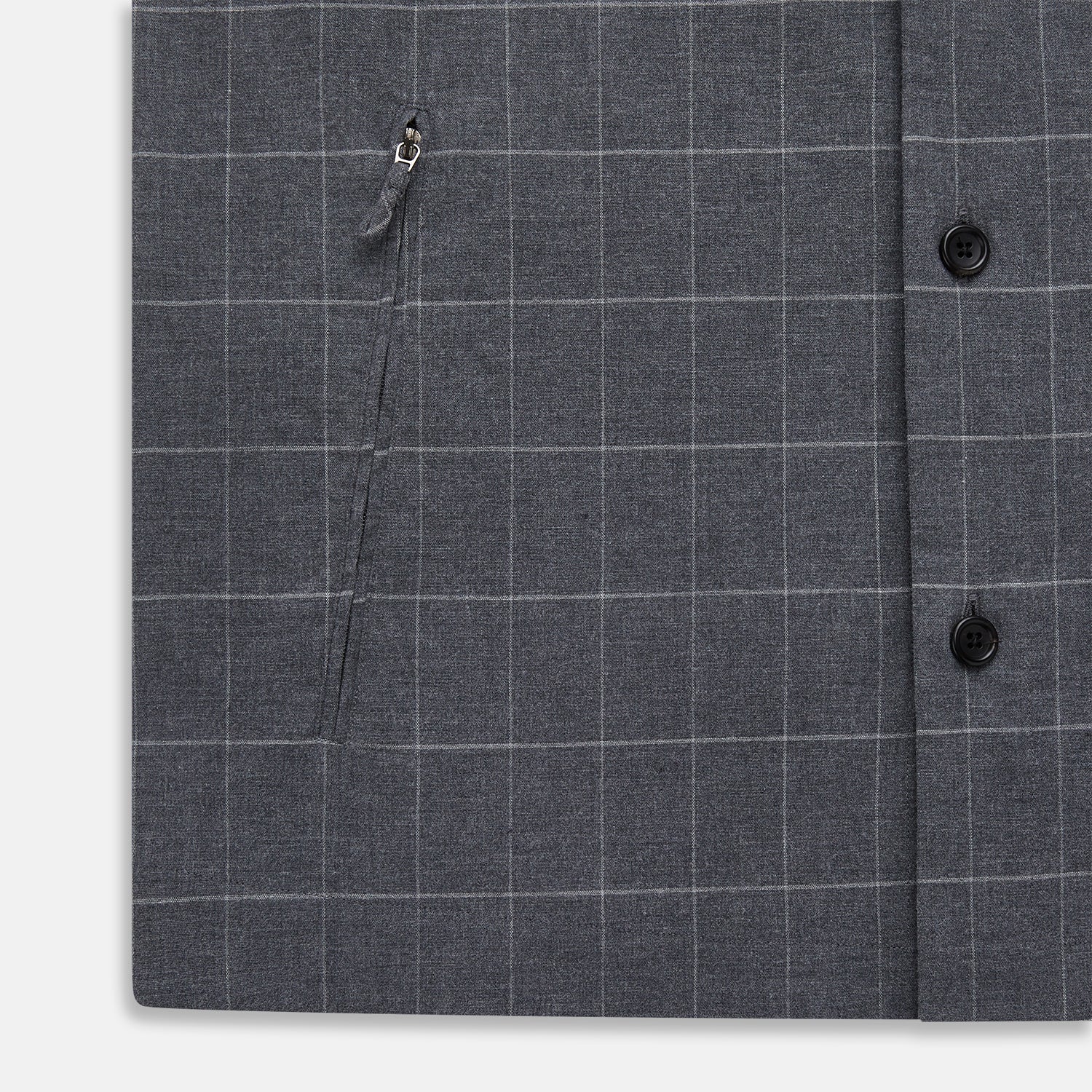 View 7 of product The Turnbull & Asser Charcoal Melange Check Hampstead overshirt, a long-sleeve button-up with a collar and two zippered side pockets, is laid flat on a light gray background.