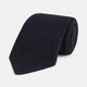 The GRENADINE NAVY TIE by Turnbull & Asser—a rolled, dark navy blue textured tie—serves as an essential accessory for smart outfits, shown against a plain white background.