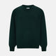 The Turnbull & Asser Petrol Green Merino V-Neck Jumper features long sleeves and ribbed cuffs and hem—an essential knitwear piece, shown against a white background.