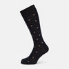 View 1 of product The Turnbull & Asser Midnight Patterned Mid-Length Sock features a ribbed cuff and a design of small white hexagons with red dots, shown here as a single sock on a plain white background.