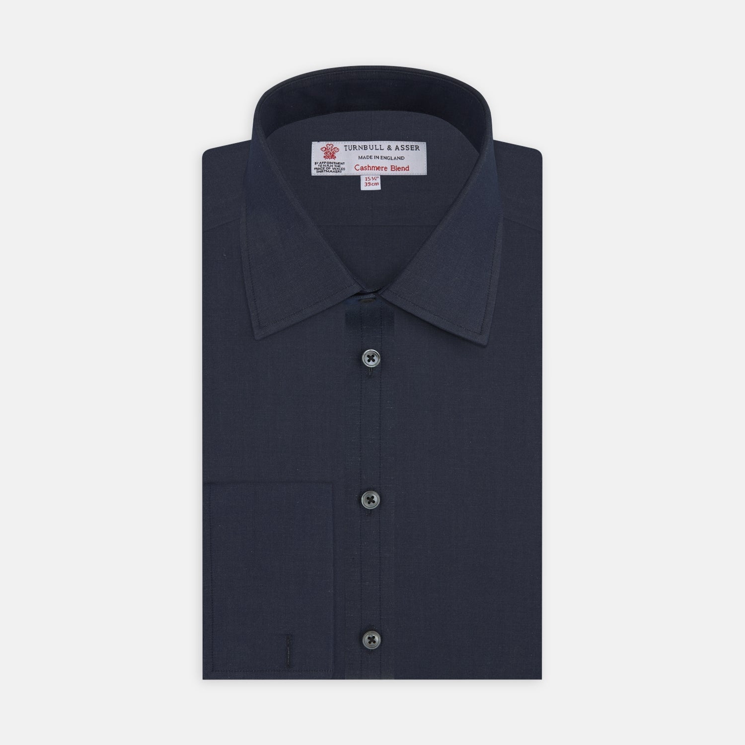 View 1 of product A neatly folded Turnbull & Asser Dark Blue Denim-Cashmere Shirt with a T&A collar and double cuffs, featuring black buttons, shown on a white background. The label inside the collar highlights its smart finish and refined style.