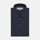 A neatly folded Turnbull & Asser Dark Blue Denim-Cashmere Shirt with a T&A collar and double cuffs, featuring black buttons, shown on a white background. The label inside the collar highlights its smart finish and refined style.