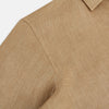 View 6 of product The Turnbull & Asser Camel Linen Windsor Shirt features long sleeves, a tailored fit, and classic collar in light brown camel linen, shown against a white background.