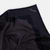 View 2 of product The Turnbull & Asser Navy and Lilac Dot Silk Pocket Square features small white polka dots with a wider border of spaced-out dots, neatly folded to showcase both sides of its handmade silk fabric.