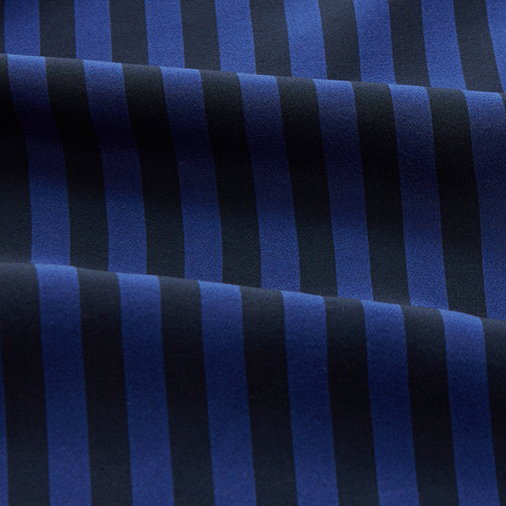 The Turnbull & Asser Navy and Blue Multi Stripe Silk Holiday Fit Winnington Shirt features white buttons, a notched collar, and a chest pocket, shown laid flat on a white background.