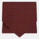 The Great Gatsby Burgundy Printed Silk Cravat by Turnbull & Asser features a maroon silk fabric with a small yellow and blue geometric pattern, subtle sheen, and neatly finished edges for an elegant, Gatsby-inspired formal accessory.