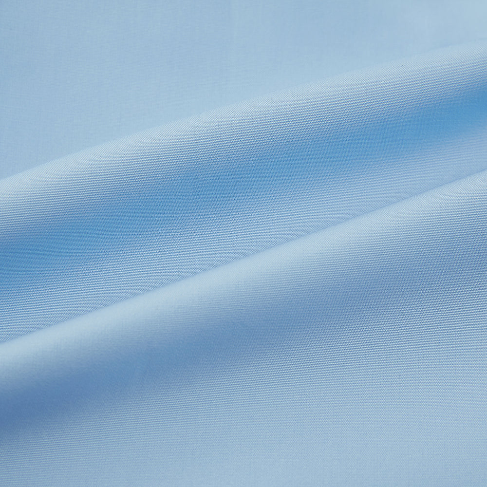 The Turnbull & Asser Dr. No Blue Cotton Shirt with cocktail cuffs, inspired by James Bond, features a classic collar and white buttons, displayed on a plain white background.