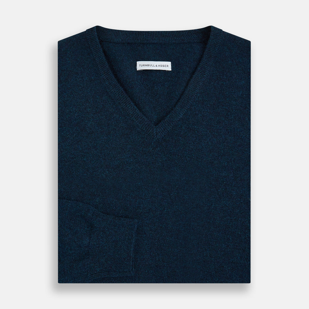 The Turnbull & Asser Dark Green Melange Cashmere V-neck Jumper features long sleeves, ribbed cuffs and hem—an essential piece of classic knitwear displayed on a white background.