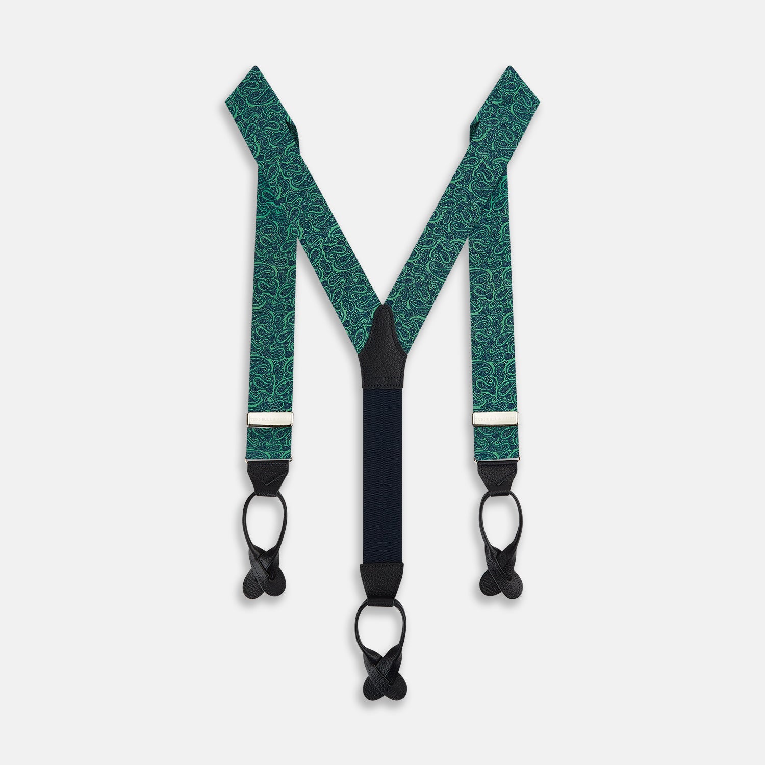 View 1 of product Turnbull & Asser's Kelly Green Paisley Adjustable Silk and Navy Leather Braces feature a bold paisley pattern, adjustable fit, and navy leather detailing. Shown flat on a white background—ideal for refined, elegant styling.