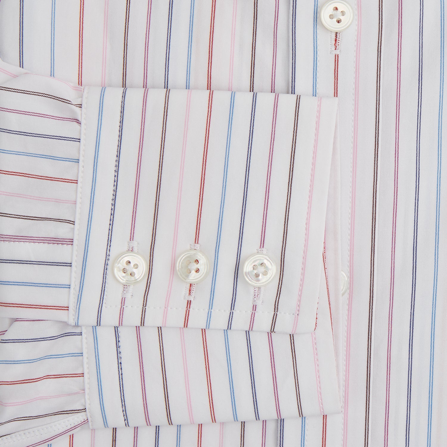 View 4 of product The Pink and Blue Multi Double Pinstripe Mayfair Shirt by Turnbull & Asser is a long-sleeve, button-up with a T&A collar, buttoned cuffs, and thin blue, red, and white stripes on a light background for a classic, formal look.