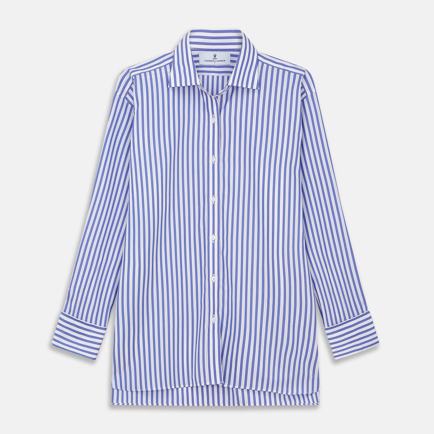 View 1 of product The Turnbull & Asser Pale Blue Candy Stripe Cotton Marlene Shirt is an oversized women's collared shirt with long sleeves, buttoned cuffs, and vertical blue and white stripes, shown laid flat on a white background.