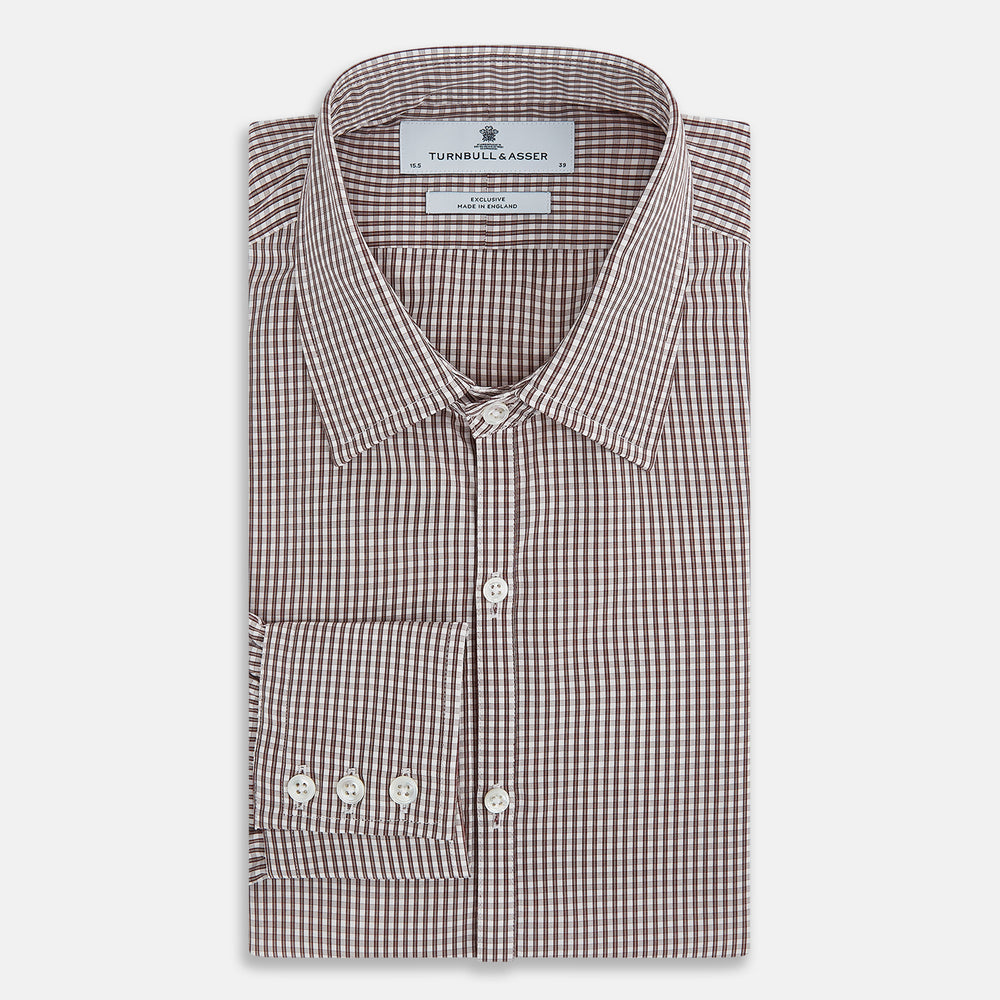 The Turnbull & Asser Burgundy Micro Check Westminster Shirt is a long-sleeved button-up with a classic collar and tailored fit, featuring a subtle micro check pattern, shown against a white background.