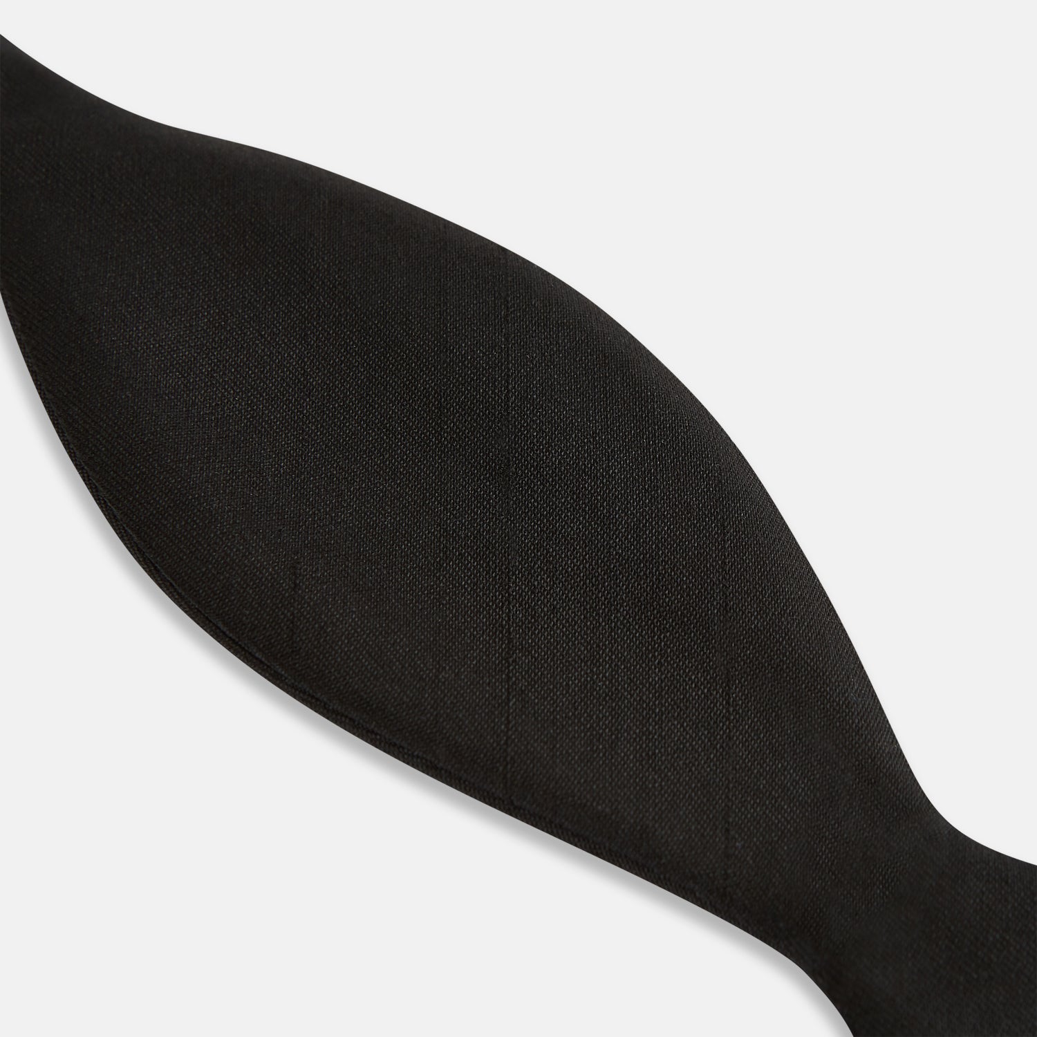 View 4 of product The Casino Royale Shantung Silk Bow Tie by Turnbull & Asser, as seen on James Bond, features a classic shape in black silk and is set against a plain white background—a timeless gentleman’s accessory.