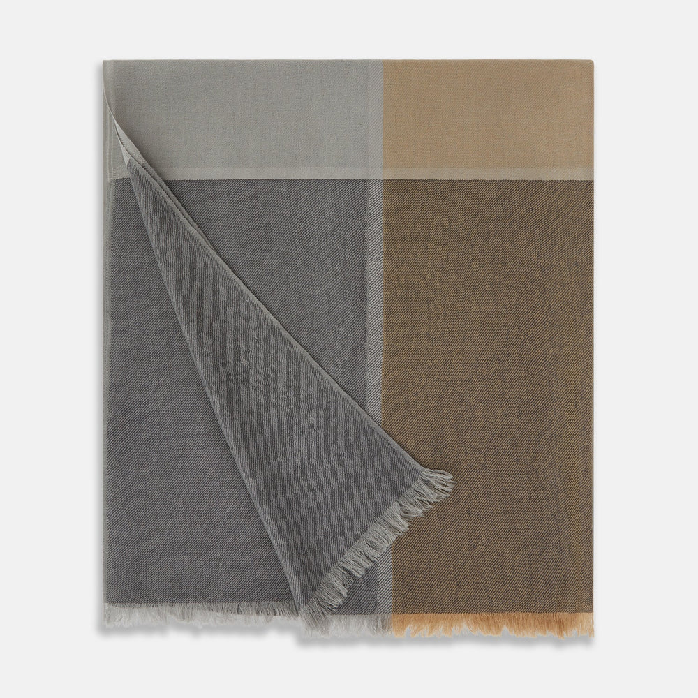 The Turnbull & Asser Grey and Beige Cashmere Scarf features beige, tan, gray, and charcoal color blocks in a rectangular shape with fringed edges at both ends, elegantly displayed against a plain white background.