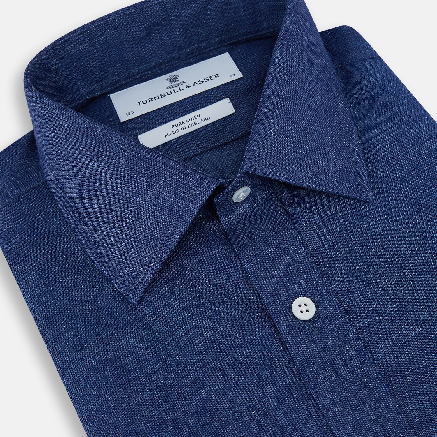 View 2 of product The Turnbull & Asser Navy Linen Mayfair Shirt features long sleeves, a button-up front with white buttons, pointed collar, buttoned cuffs, and a classic fit in solid dark blue linen, shown on a white background.