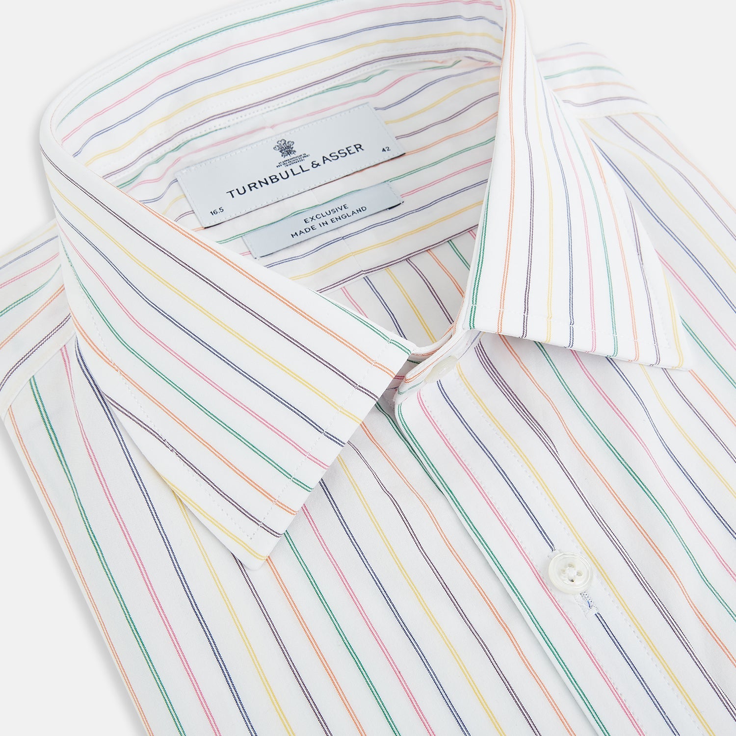 View 2 of product The Turnbull & Asser Rainbow Double Pinstripe Mayfair Shirt is a pure cotton, long-sleeved button-up with a collar and buttoned cuffs, featuring colourful blue, red, and yellow stripes on white, displayed on a plain white background.