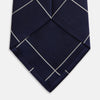 View 4 of product The Turnbull & Asser WINDOW PANE NAVY WHITE TIE features navy blue silk with a subtle diagonal ribbed texture and white windowpane checks, making it the perfect men’s accessory for any formal occasion.