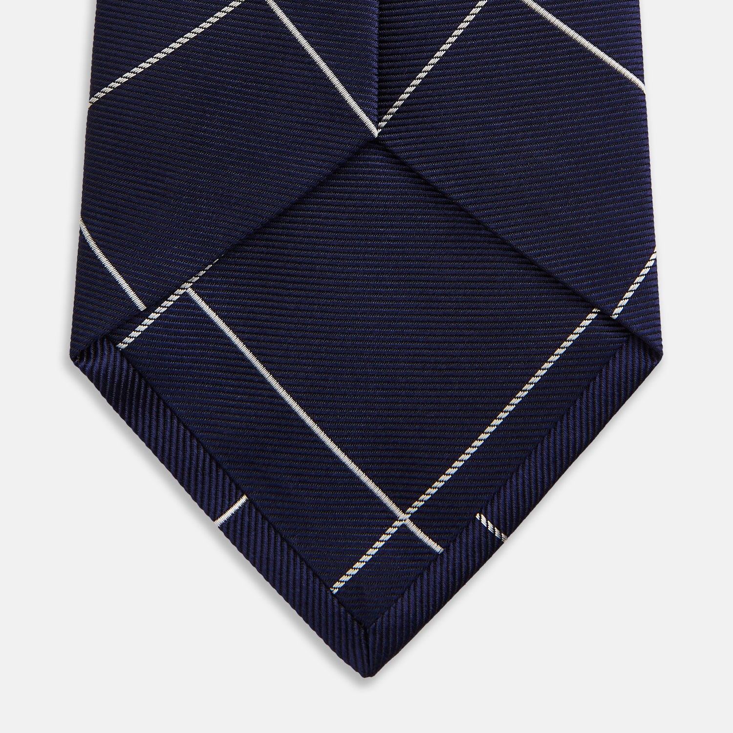 View 4 of product The Turnbull & Asser WINDOW PANE NAVY WHITE TIE features navy blue silk with a subtle diagonal ribbed texture and white windowpane checks, making it the perfect men’s accessory for any formal occasion.